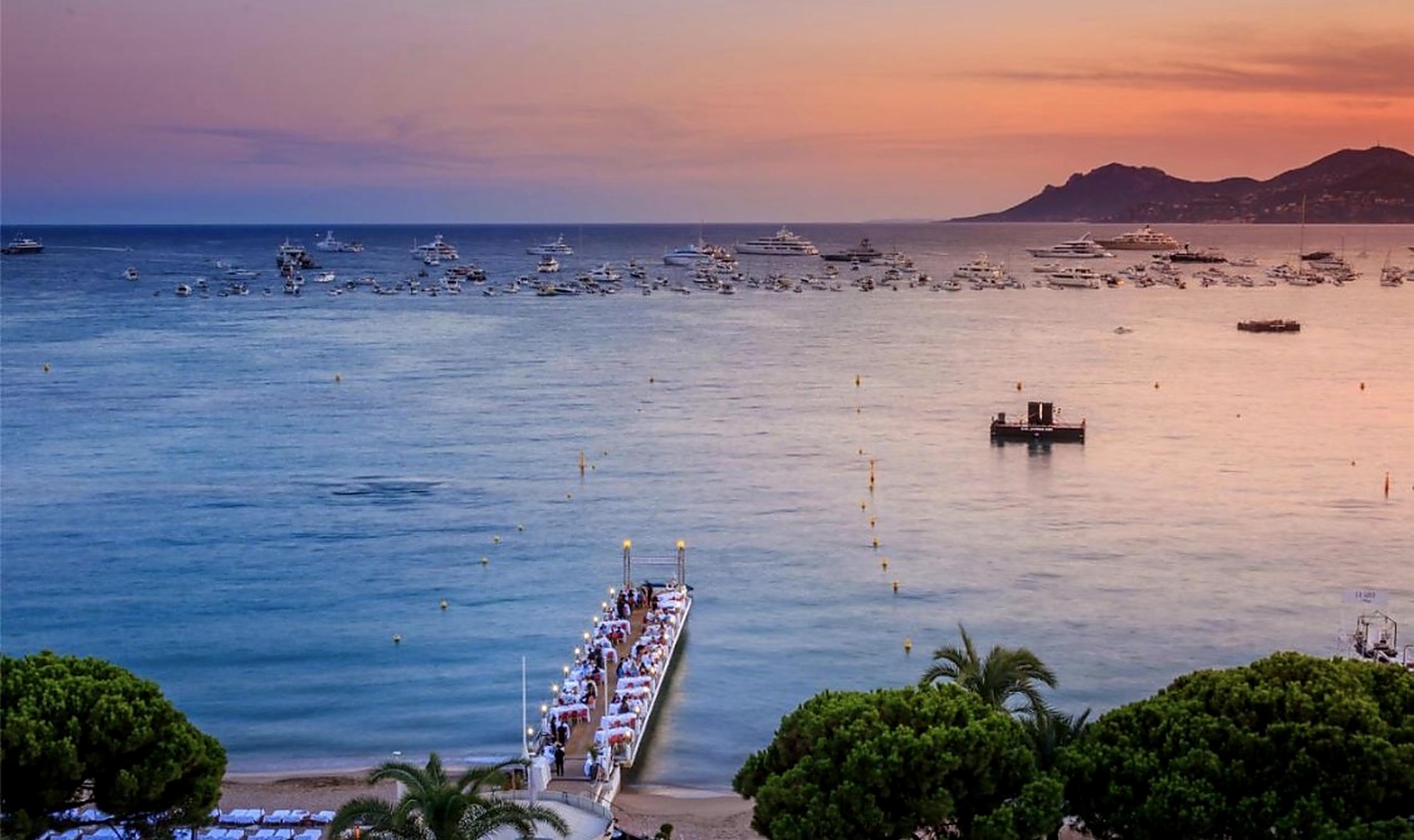 Dining pier over the sea at sunset in Cannes